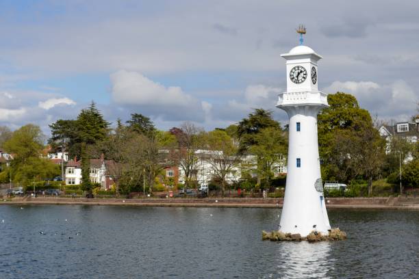 Roath Park clock tower and lake, Cardiff, UK The freshly-painted clock tower in Roath Park, Cardiff. cardiff wales stock pictures, royalty-free photos & images