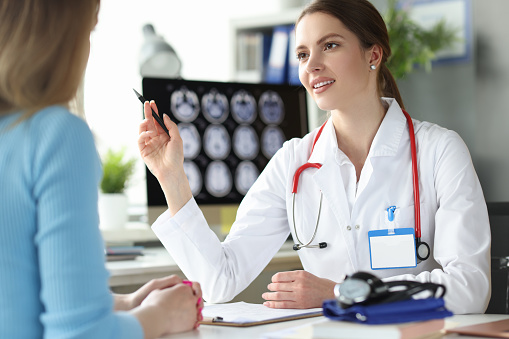 Female doctor consults patient on health issues. Medical therapeutic services concept