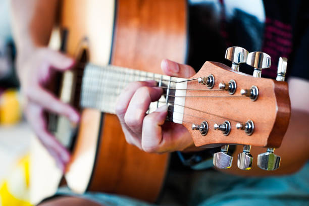 istock Practicing guitar playing a beautiful Asian man playing guitar 1315179939