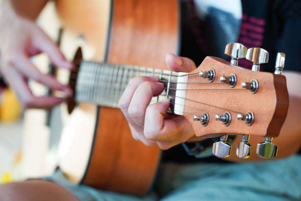 istock Practicing guitar playing a beautiful Asian man playing guitar 1315179940