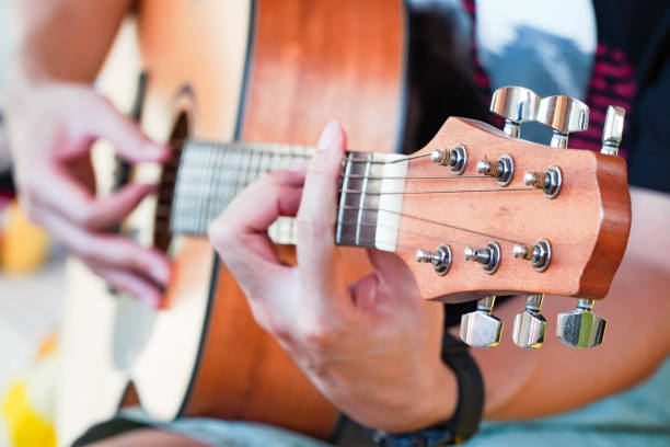 istock Practicing guitar playing a beautiful Asian man playing guitar 1315179956