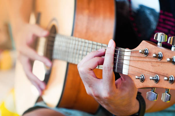 istock Practicing guitar playing a beautiful Asian man playing guitar 1315179957