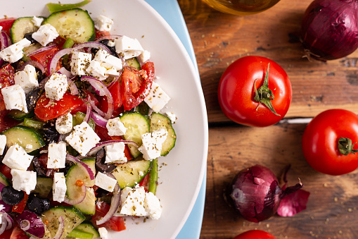 Greek salad with feta cheese, green peppers, black olives, tomatoes. Ideas for summer, light and fast lunch. Nutritious and complete food.