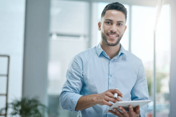 istock Shot of a young businessman using a digital tablet in a modern office 1315185379