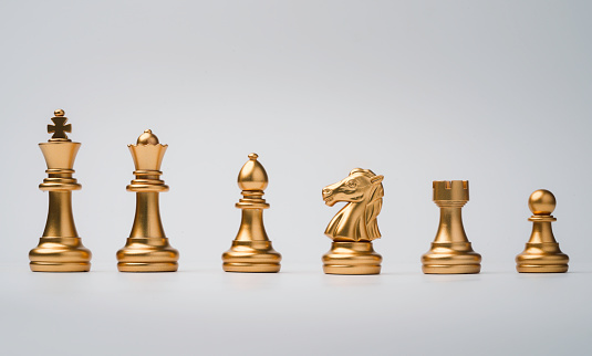 Golden chess include king queen horse ship and pawn on white background.