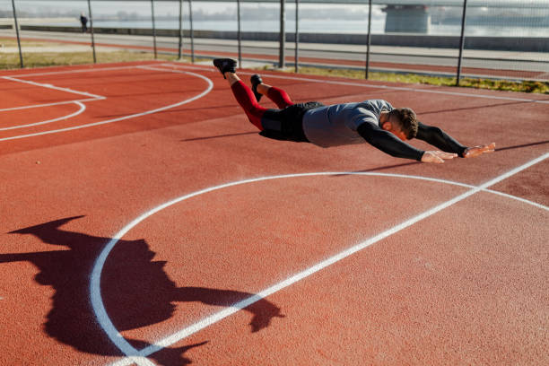 istock Attractive muscular man doing push-ups outdoors. Push-ups with the fly. 1315189859