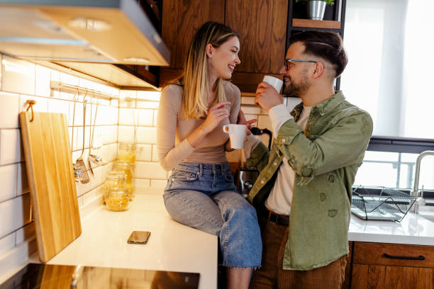 istock Blissful couple drinking coffee in stylish kitchen. 1315189942