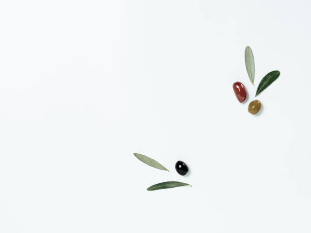istock Olives with leaves on white, copy space, top view 1315190750