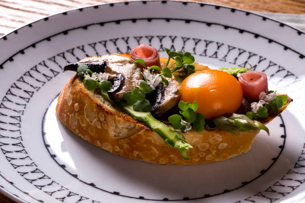 istock Bruschetta with fried mushrooms and egg yolk on a plate 1315190939