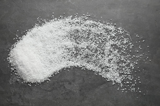 istock Natural sea salt on grey table, flat lay 1315194552