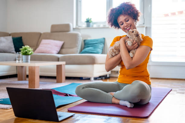istock Young cheerful woman peting a little puppy during exercizing 1315194834