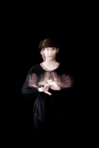 Long exposure of young woman moving hands