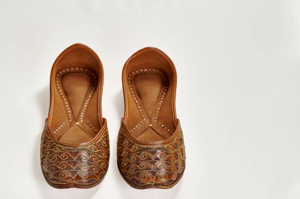 Traditional pure leather footwear (jutti) from India Traditional pure leather footwear (jutti) from India on a white background handmade indian shoes on white stock pictures, royalty-free photos & images