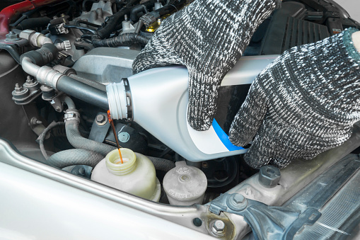 Pouring new steering fluid to old car engine, Car service.