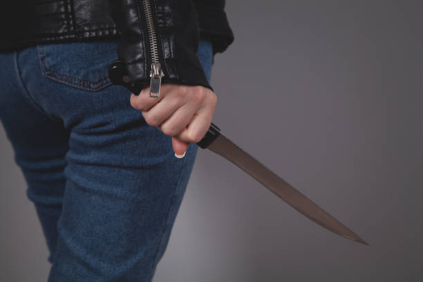 istock Caucasian killer knife in hand. Crime concept. 1315202198