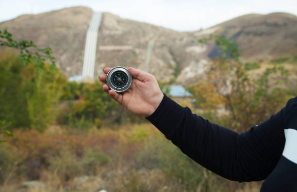 istock Woman hand with magnetic compass in mountains. 1315202302