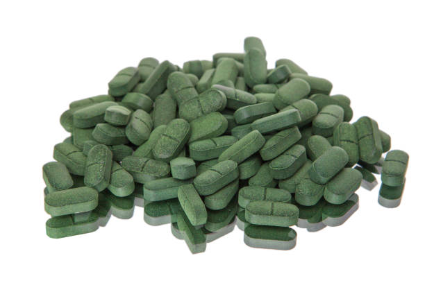 istock Spirulina tablets on white background, Isolated on white. 1315202393