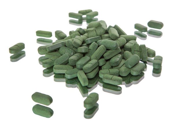 istock Spirulina tablets on white background, Isolated on white. 1315202471
