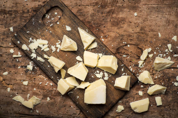 White chocolate pieces on a wooden table White chocolate pieces on a wooden table tabletop top view chocolate white chocolate chocolate chip white stock pictures, royalty-free photos & images