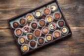 Luxurious chocolate praline candies set with nuts and dried fruits