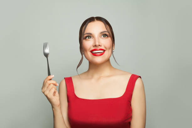 istock Happy woman with empty fork on white background. Food temptation. 1315204331