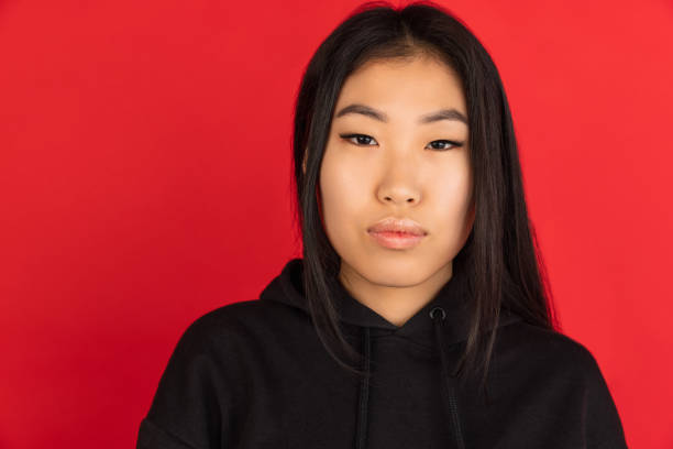 istock Asian young girl's portrait isolated on red studio background. 1315204848