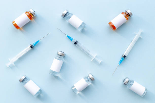 istock Vaccination with Covid vaccine in bottles with syringe 1315205366