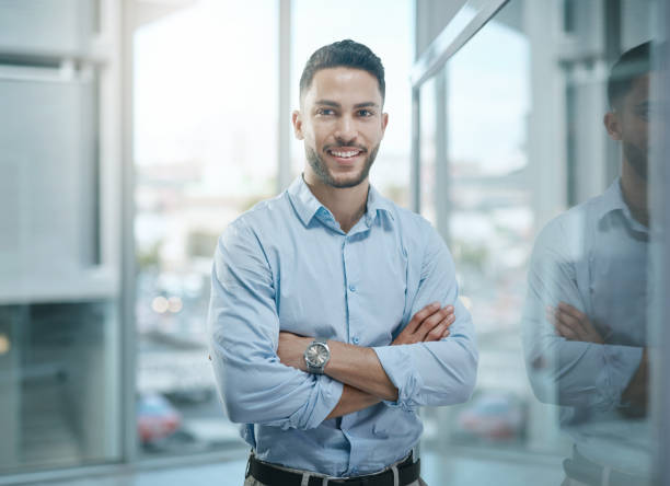 Portrait of a confident young businessman working in a modern office stock photo