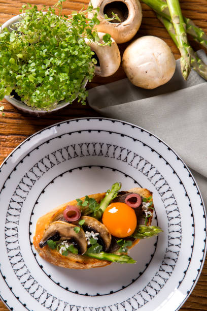 istock Bruschetta with fried mushrooms and egg yolk on a plate 1315207073