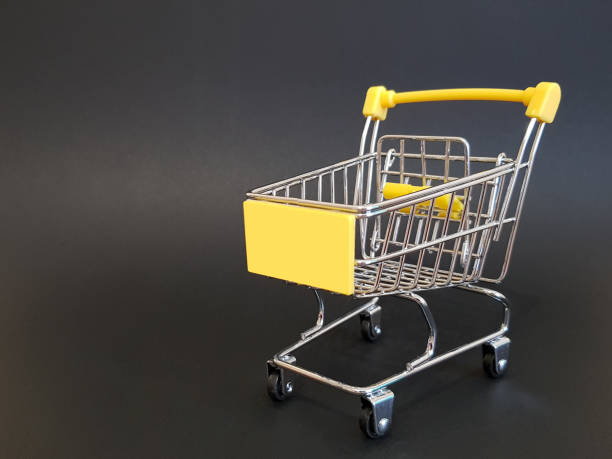 istock Yellow toy cart on black isolated background 1315207151