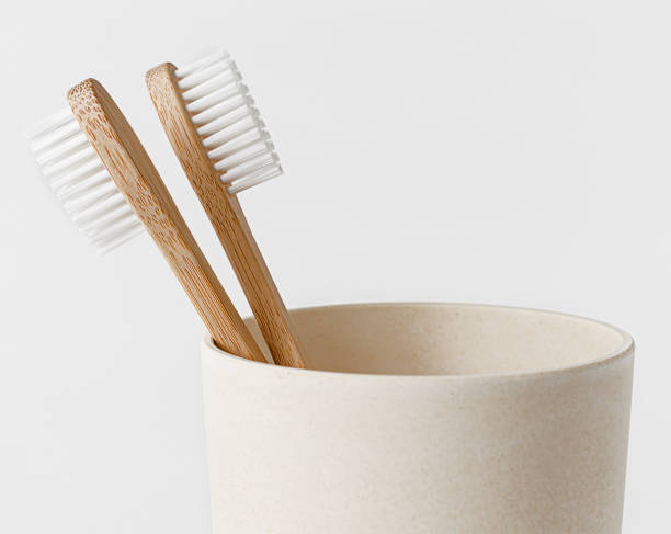 istock Bamboo toothbrushes in eco cup on white background. Copy space, close up. Zero waste concept. 1315210336