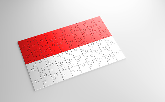 A jigsaw puzzle with a print of the flag of Indonesia, pieces of the puzzle isolated on white background. Fulfillment and perfection concept. Symbol of national integrity. 3D illustration.