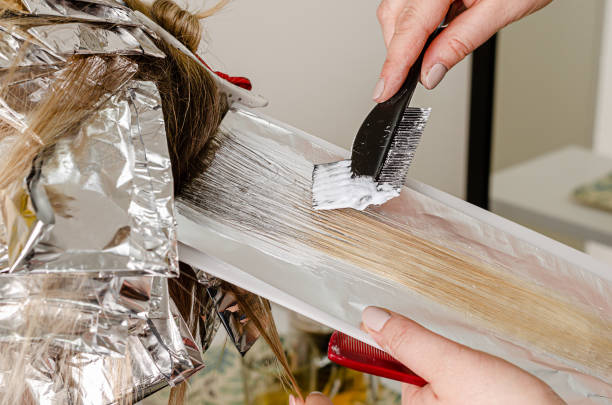 Applying bleaching powder on hair