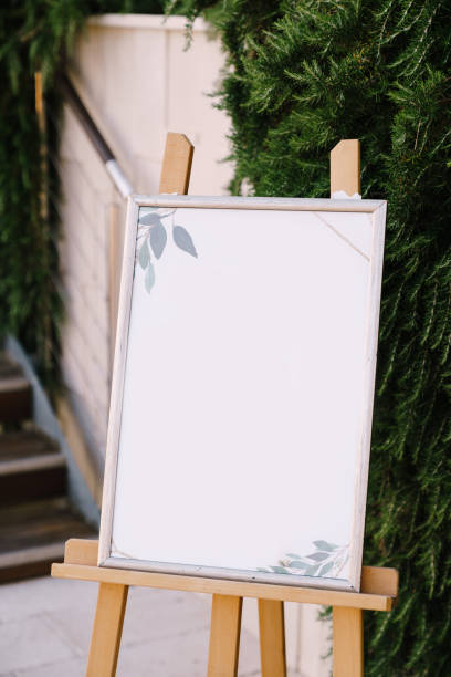istock Empty plastic easel in wooden stand on coniferous wood background 1315213253