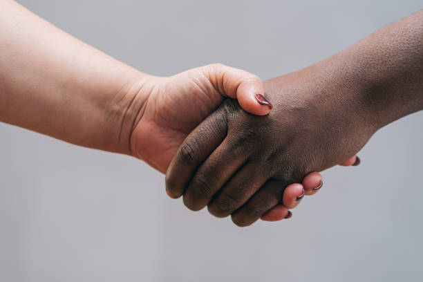 istock Multi race hands joined together, on a gray background. No racism - Empowerment and equal rights concept 1315213842