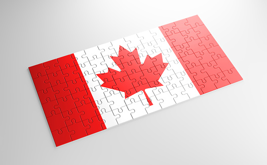 A jigsaw puzzle with a print of the flag of Canada, pieces of the puzzle isolated on white background. Fulfillment and perfection concept. Symbol of national integrity. 3D illustration.