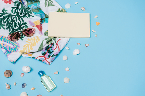 Flat Lay of Woman Summer  Personal Accessories on Blue Background