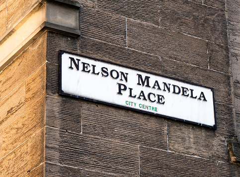 Close-up of a street sign for Nelson Mandela Place, situated just off Buchanan Street in Glasgow's city centre. Previously known as St George's Place, it was renamed in 1986, in solidarity with Nelson Mandela's struggle for justice.