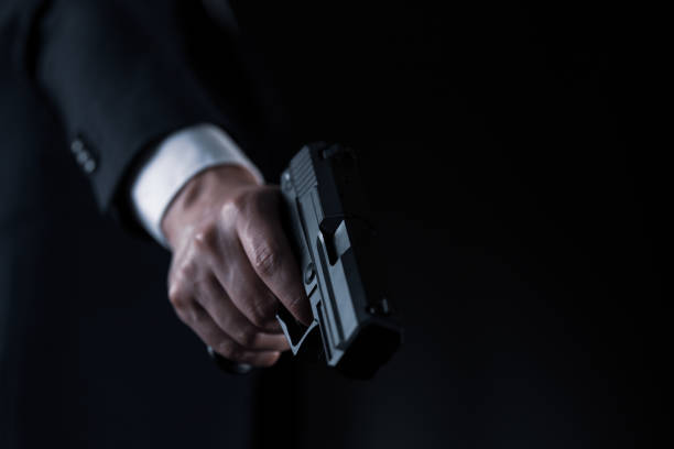 istock Man in a suits and holding modern semi-automatic pistol 1315217622