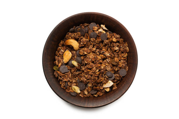 istock Chocolate granola cereal with nuts in a bowl background. 1315217867