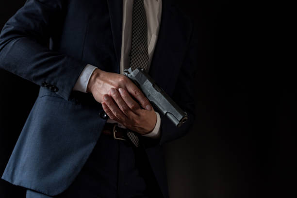 istock Man in a suits and holding old semi-automatic pistol 1315217942