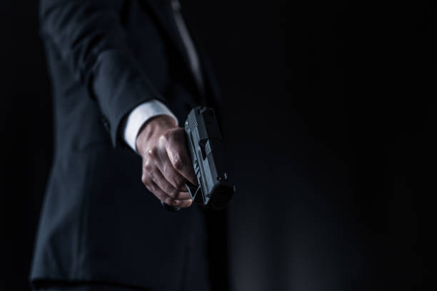 istock Man in a suits and holding modern semi-automatic pistol 1315217992
