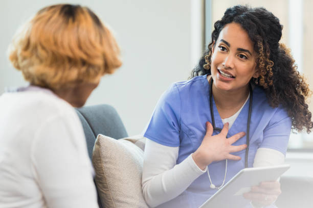 istock Nurse gestures to self while talking to unrecognizable senior woman 1315220335