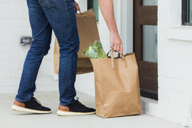 istock Unrecognizable delivery person leaving grocery order 1315220470