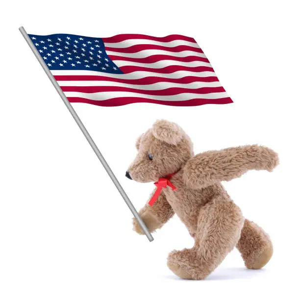 Photo of United states of America flag stars and stripes old glory being carried by a cute teddy bear