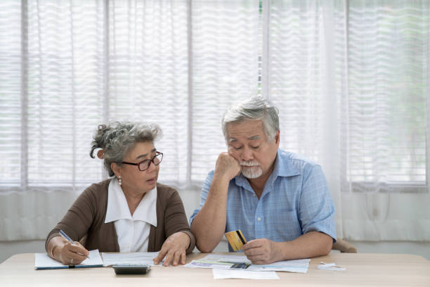 stressed asian elderly couple, they are trying to get money to pay off their credit card debt, financial problems from the coronavirus or covid-19 outbreak. - credit crunch wallet home finances credit card imagens e fotografias de stock