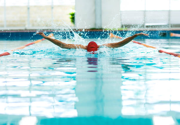 Young athletic man swimming in olympic pool. stock photo