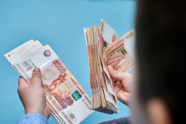 istock hands close-up consider a large currency of Russian rubles 1315224142