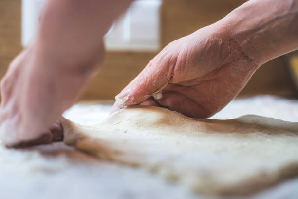 istock Rolling traditional dough in the kitchen, close up 1315224316