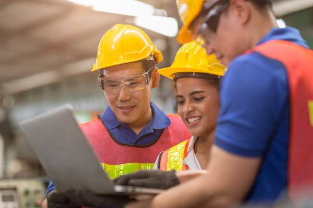 istock engineer women working with male team mix race work help together in heavy industry with laptop computer discussion, join partner good teamwork. 1315224775